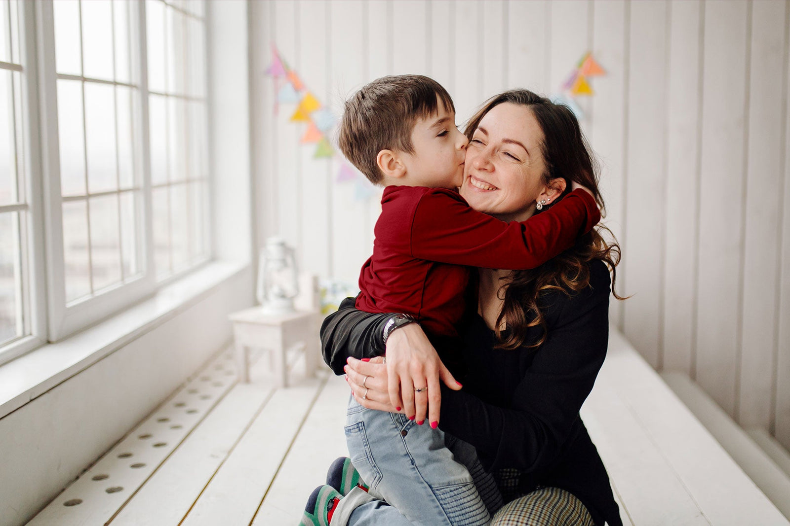 Mom and son hugging and wearing warm merino wool clothes