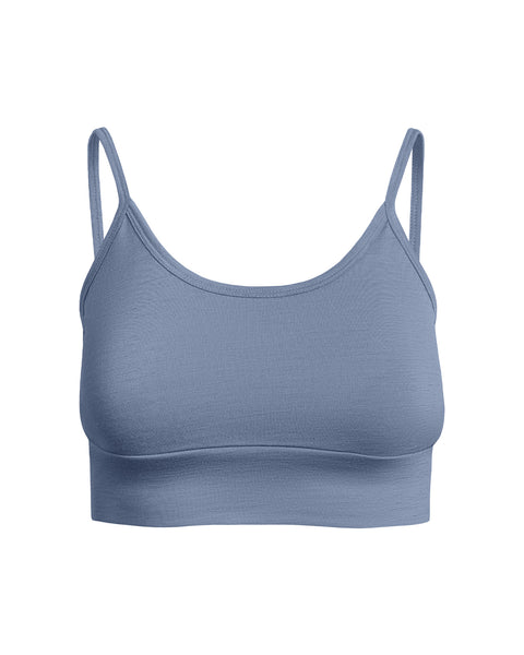 A flat-lay product shot of a women's bralette in a dusty blue color, displayed upright against a pure white background. The bralette features a scoop neckline, thin shoulder straps, and a wide band at the bottom. The fabric has a smooth texture.