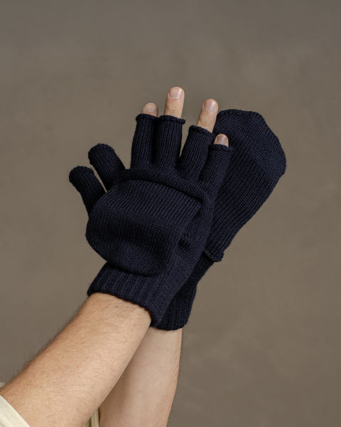 Close-up of dark blue merino wool convertible gloves showing flip-top mitten design and flexible finger openings.