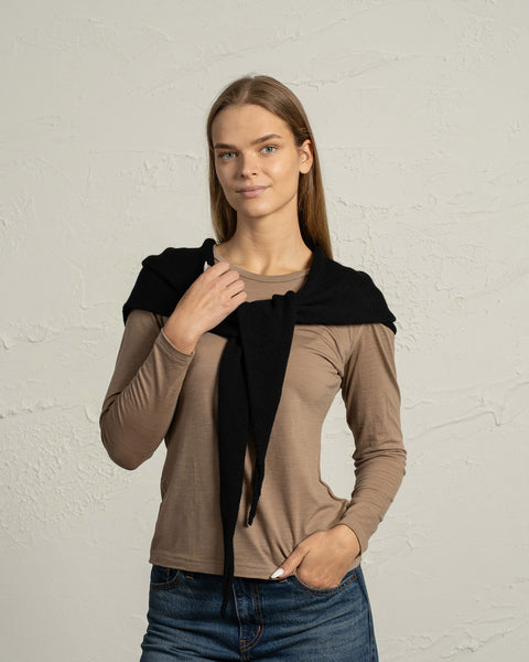 Black merino wool knit bandana styled over shoulders on a woman.