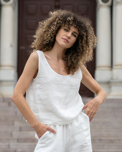 Woman standing outdoor and wearing Linen Sleeveless Crop Top Ana in Pure White color