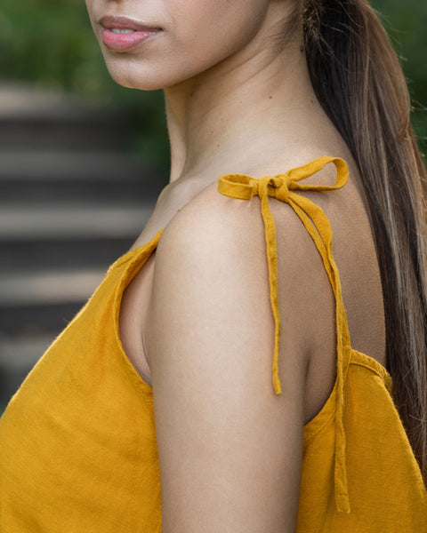 Woman is showing her dress' shoulder straps