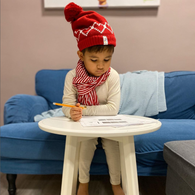 A kid wearing merino wool base layers in natural color.