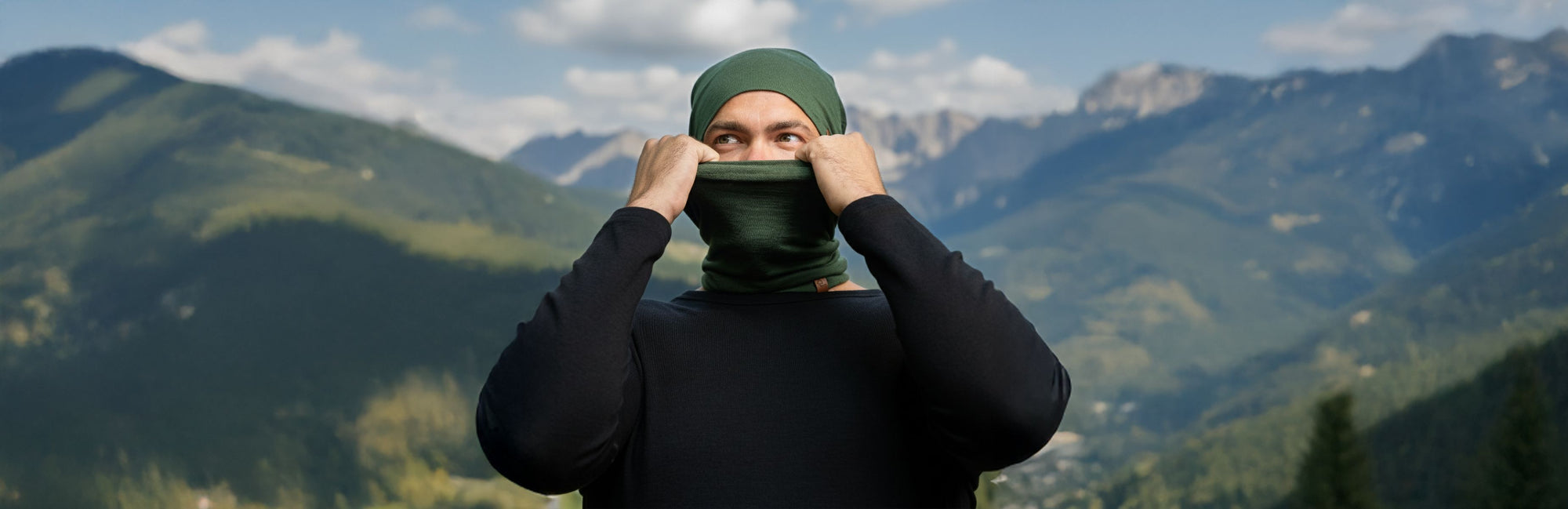 Person wearing a green headscarf with mountains in the background