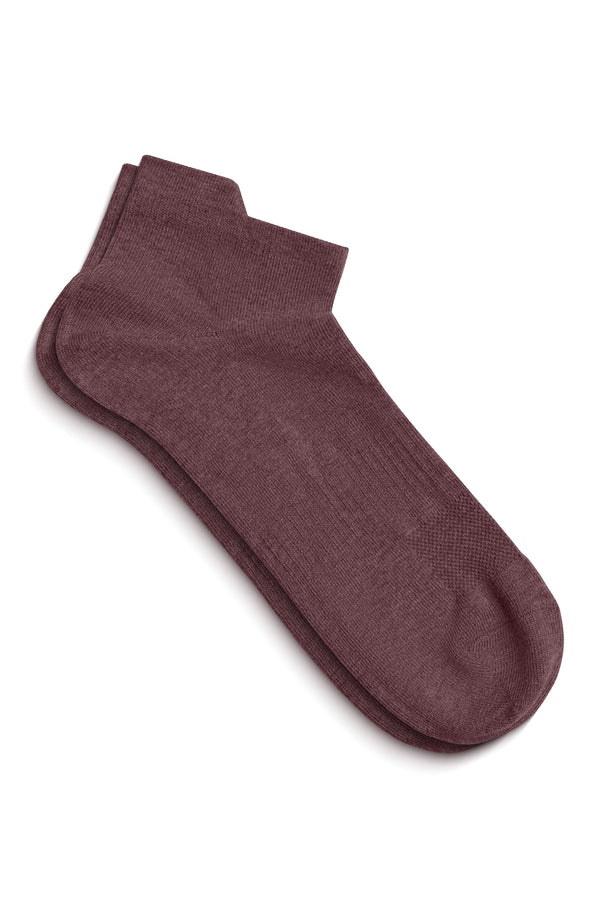A pair of dark pink ankle socks lying flat on a white surface, slightly overlapping to show the top of the foot and the ankle opening.