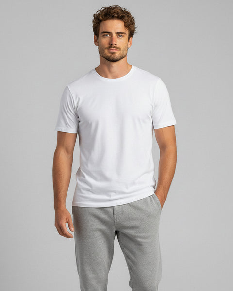 Man wearing a white bamboo t-shirt and gray pants, standing in a relaxed pose.