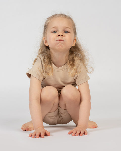 Girl in beige bamboo t-shirt and shorts – lightweight comfortable kids loungewear set