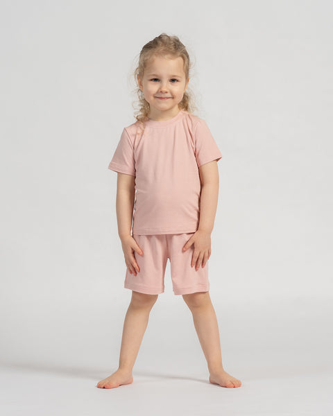 Kids pink bamboo t-shirt and shorts set, lightweight and gentle clothing for daily wear.