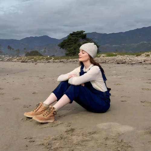 A woman wearing the pinafore jumpsuit NICCI in storm blue color. 