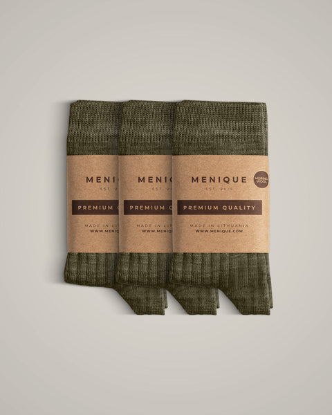 A 3-pack of kids’ olive green ribbed merino wool socks, neatly wrapped with branded kraft paper labels.