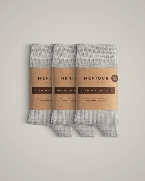 A 3-pack of kids’ light gray ribbed merino wool socks with Menique branding.