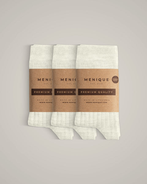 A 3-pack of kids’ natural off-white ribbed merino wool socks with kraft labels.