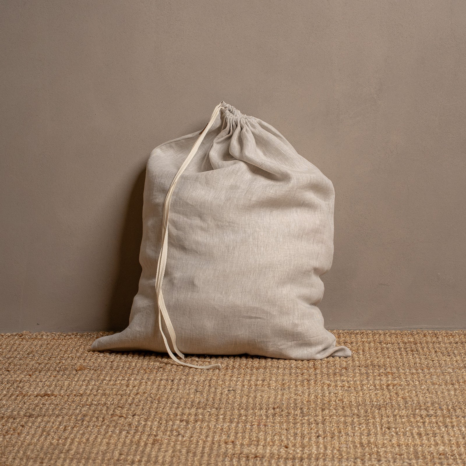 Linen laundry bag with white drawstrings