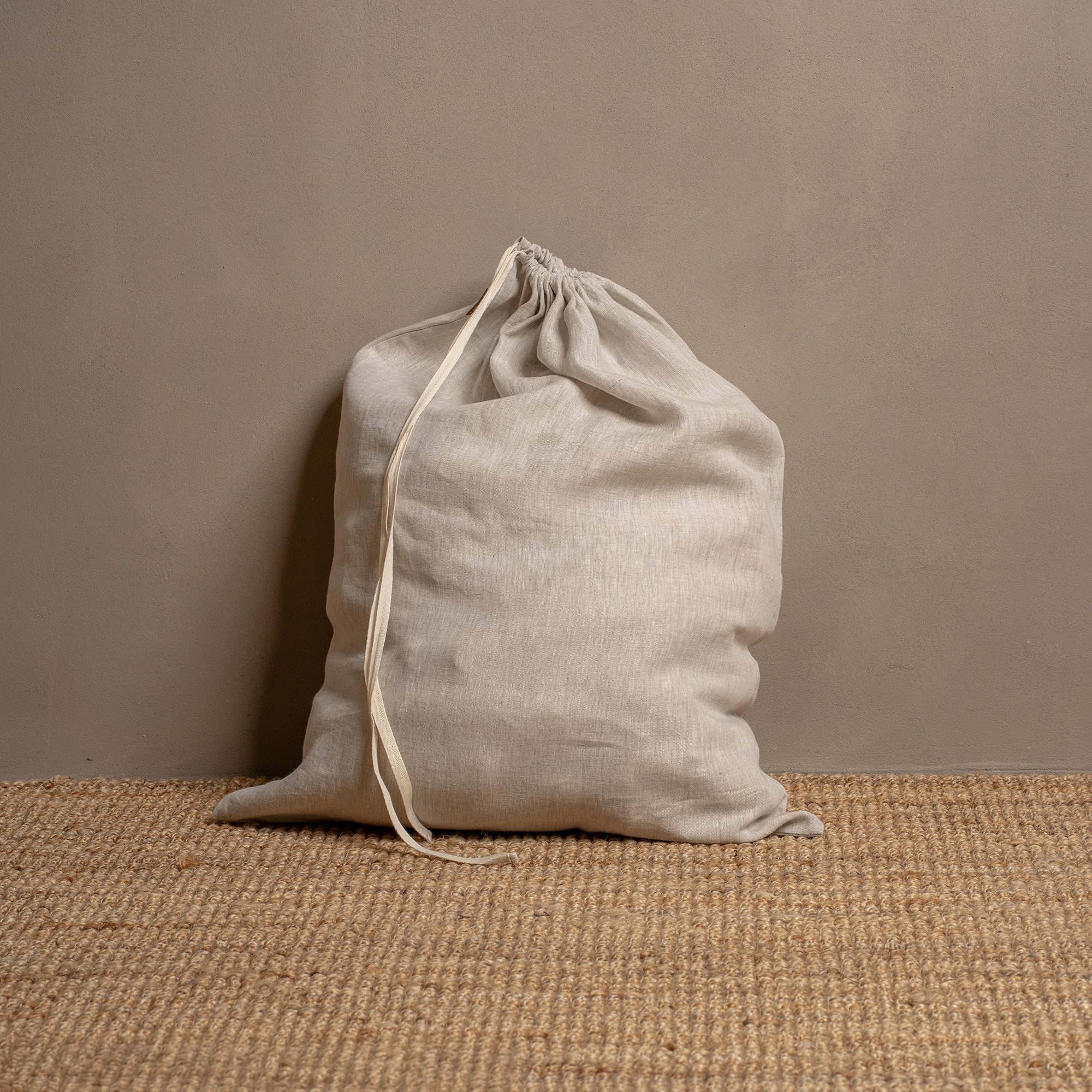 Linen laundry bag with white drawstrings