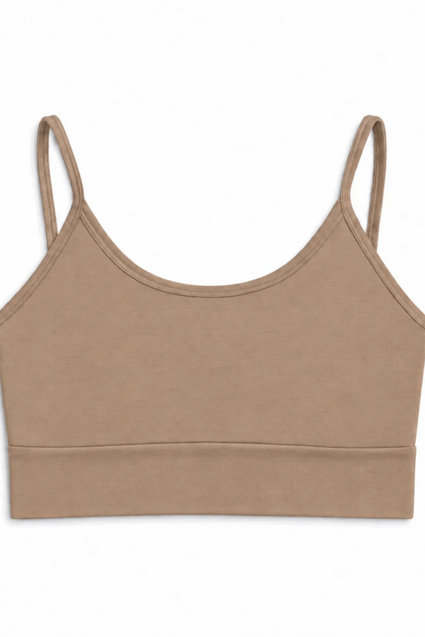 A beige bralette with a scoop neckline, wide bottom band, and thin straps displayed on a white background.