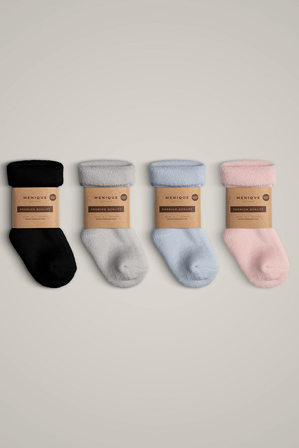 The menique kids' merino wool sherpa lined socks in all available colors, with packaging.