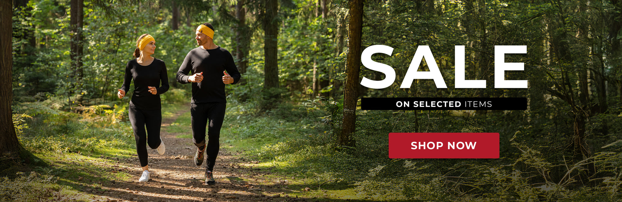 An advertisement featuring two people running in a forest, with the text "SALE ON SELECTED ITEMS SHOP NOW" displayed.



